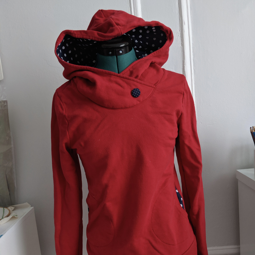 Red hoodie with blue and white polka dot detailing